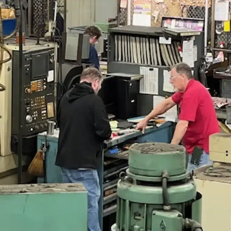 FRANTZ team members reviewing manufacturing equipment during the engineering process